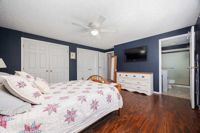 bedroom with ensuite bath, a textured ceiling, multiple closets, dark hardwood / wood-style floors, and ceiling fan