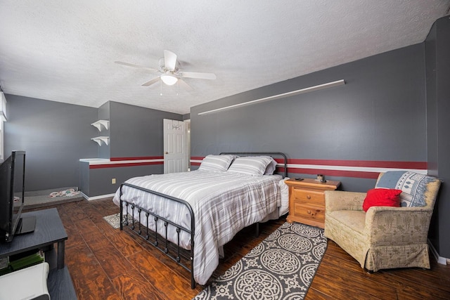 bedroom with a textured ceiling, dark wood-type flooring, and ceiling fan