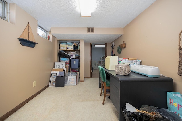 carpeted office with a textured ceiling