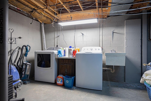 laundry room with independent washer and dryer and sink