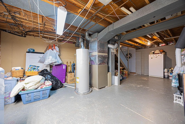 basement featuring heating unit, water heater, and white fridge