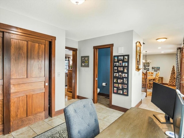 tiled home office featuring a notable chandelier