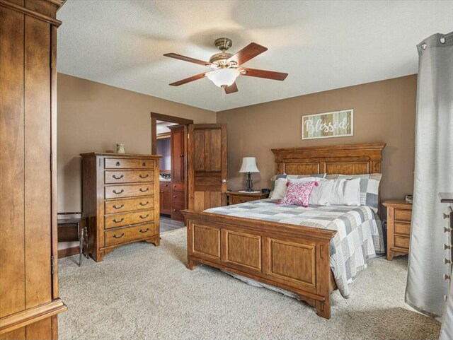 carpeted bedroom featuring a baseboard radiator and ceiling fan