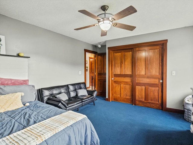 carpeted bedroom featuring a textured ceiling, a closet, and ceiling fan