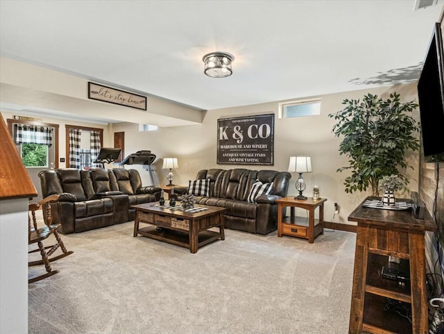 living room featuring plenty of natural light and light colored carpet