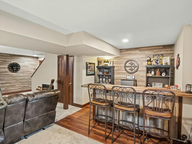 bar with wood walls and wood-type flooring