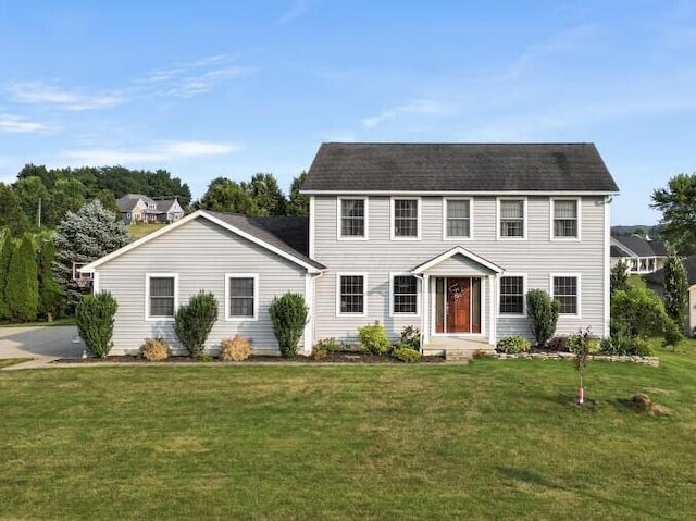 colonial inspired home with a front yard