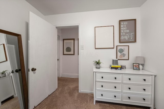 hallway with carpet floors