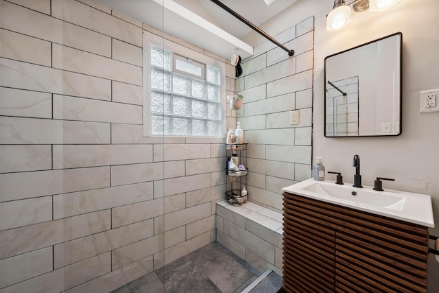 bathroom with vanity and tiled shower