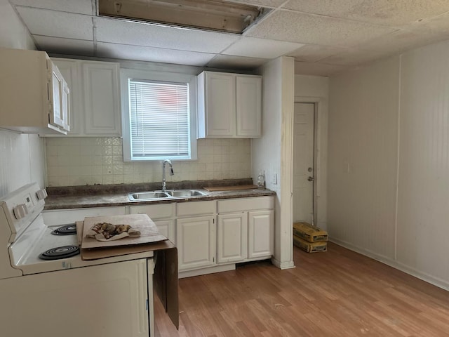 kitchen featuring a drop ceiling, sink, white cabinetry, and white electric range