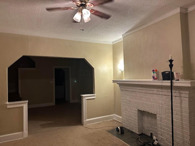 unfurnished living room with ornamental molding, ceiling fan, a textured ceiling, and a fireplace