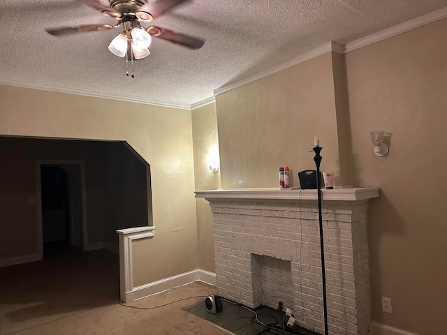 living room with crown molding, a brick fireplace, ceiling fan, and a textured ceiling