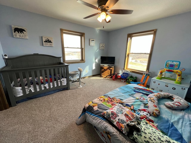 carpeted bedroom featuring ceiling fan and baseboards