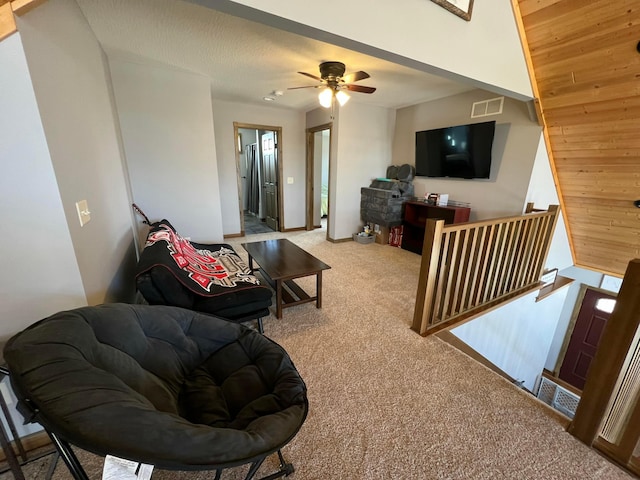 living room featuring wood ceiling, ceiling fan, and carpet