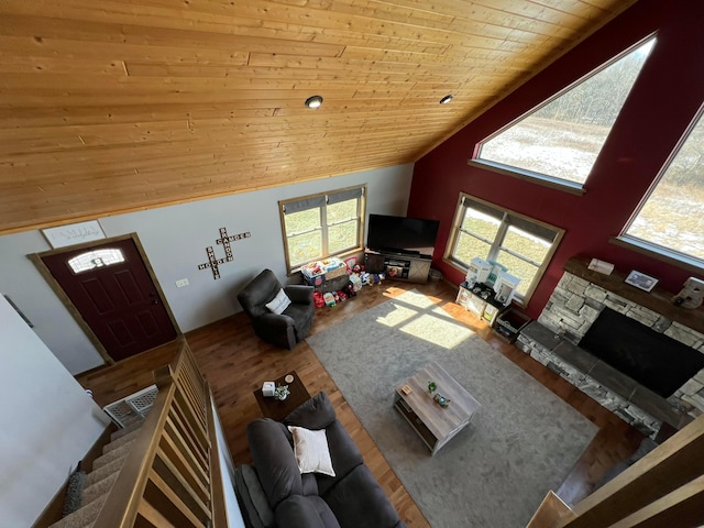 unfurnished living room with a wealth of natural light, hardwood / wood-style floors, wooden ceiling, and high vaulted ceiling