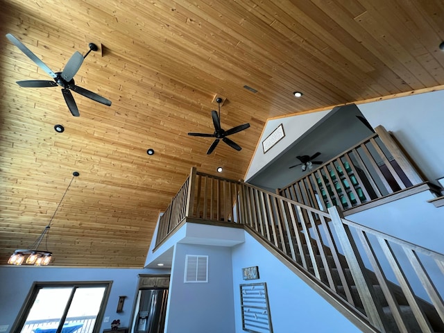 stairs with high vaulted ceiling, recessed lighting, wooden ceiling, and visible vents