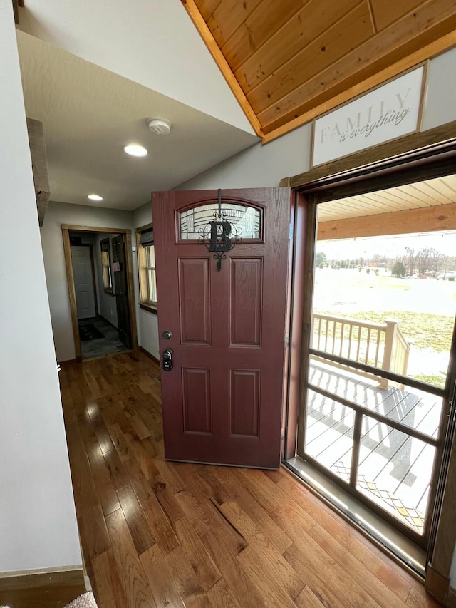 foyer entrance featuring wood ceiling, lofted ceiling, and hardwood / wood-style flooring