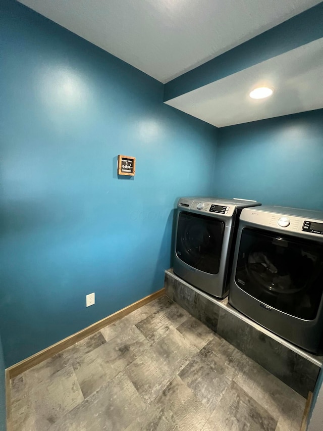 clothes washing area featuring laundry area, independent washer and dryer, and baseboards