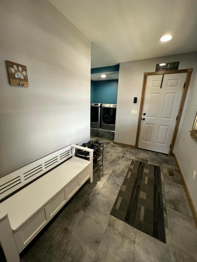 hallway with baseboards, washer and clothes dryer, and recessed lighting