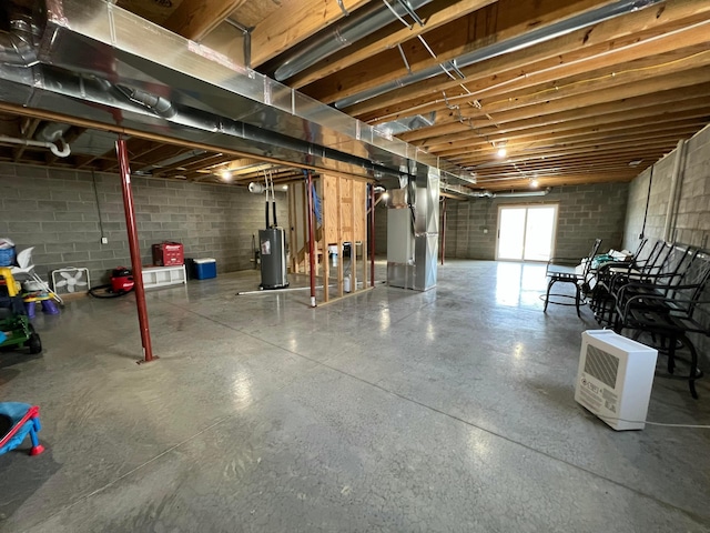 below grade area with heating unit, gas water heater, and concrete block wall