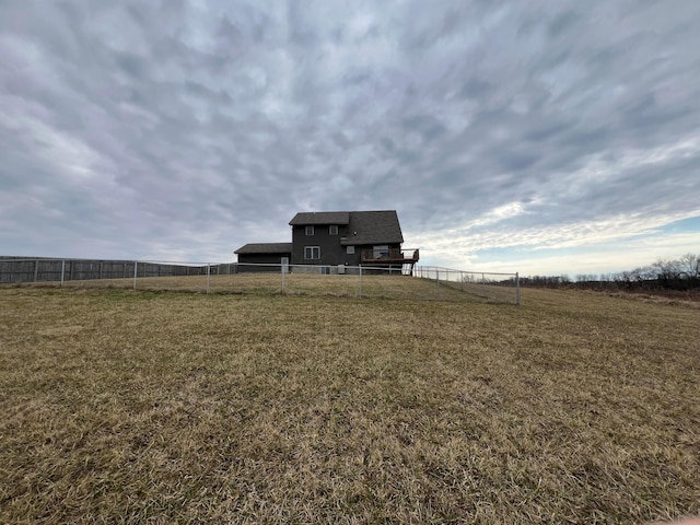 view of yard featuring fence and a rural view