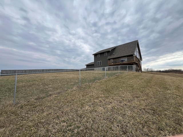 view of yard featuring fence and a deck