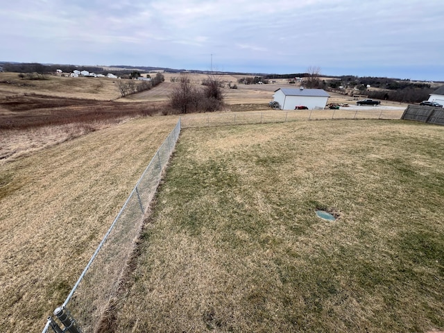 view of yard featuring a rural view and fence