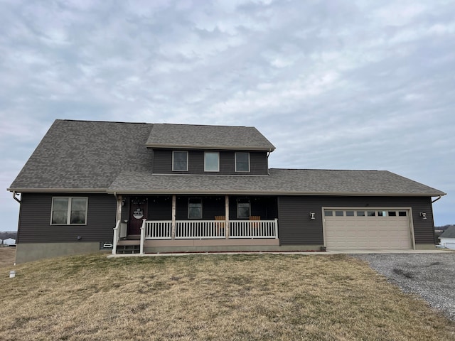 view of front of home with a garage, a front yard, covered porch, and gravel driveway