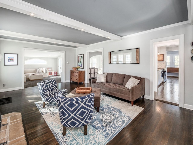 living room featuring ornamental molding and dark hardwood / wood-style floors