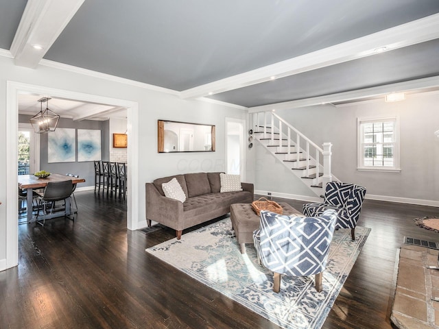 living room with a wealth of natural light, dark hardwood / wood-style floors, and beamed ceiling