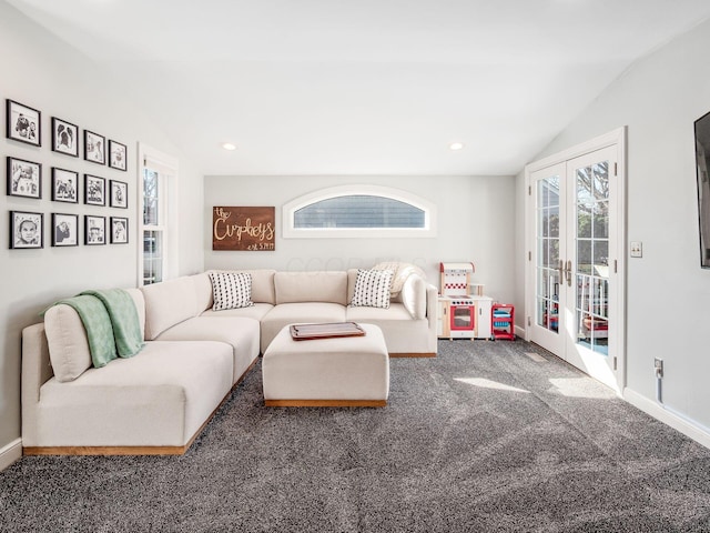 living room with lofted ceiling, carpet, and french doors