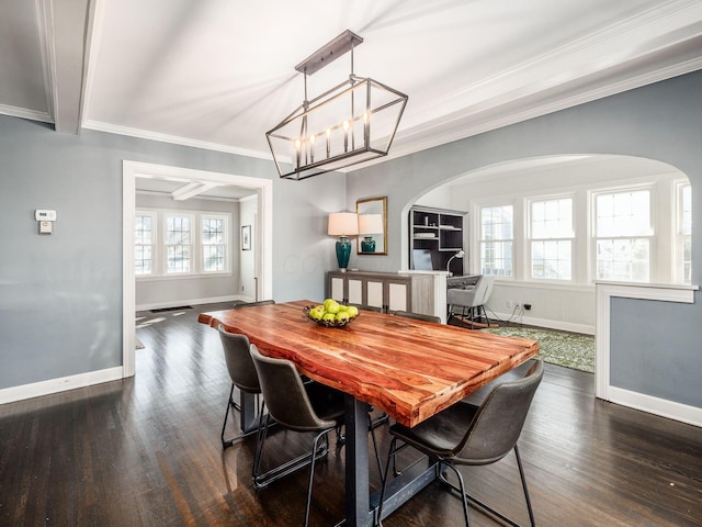 dining space featuring crown molding, an inviting chandelier, beam ceiling, and dark wood-type flooring