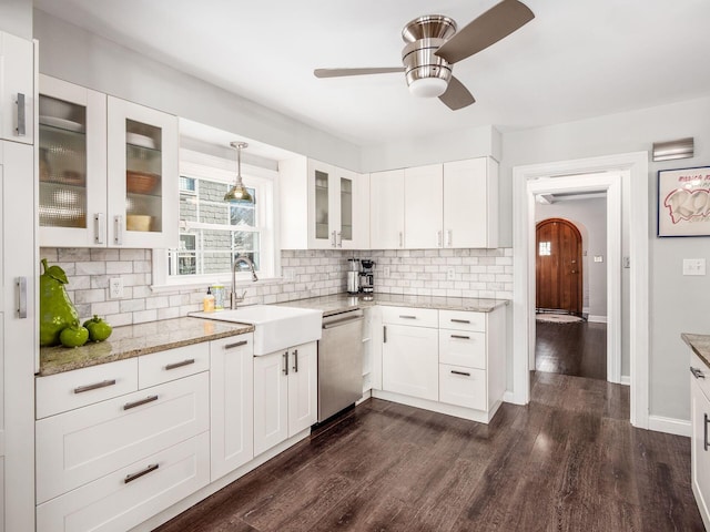 kitchen with sink, dark wood-type flooring, dishwasher, white cabinetry, and decorative light fixtures