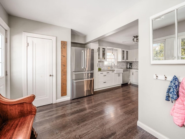 kitchen with white cabinetry, sink, backsplash, and stainless steel appliances