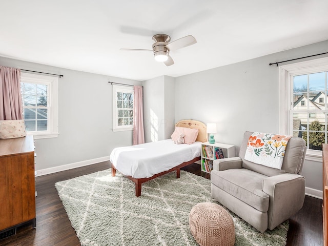 bedroom with dark hardwood / wood-style flooring and ceiling fan