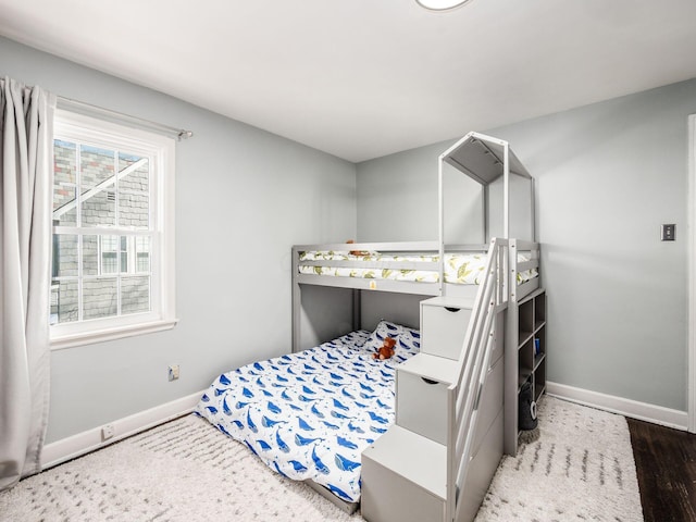 bedroom with dark wood-type flooring