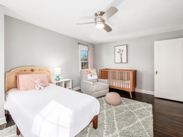 bedroom with dark hardwood / wood-style floors and ceiling fan