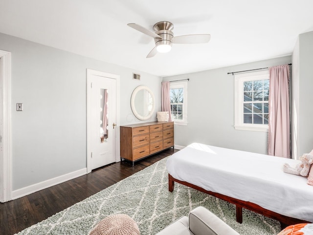 bedroom with dark hardwood / wood-style flooring and ceiling fan