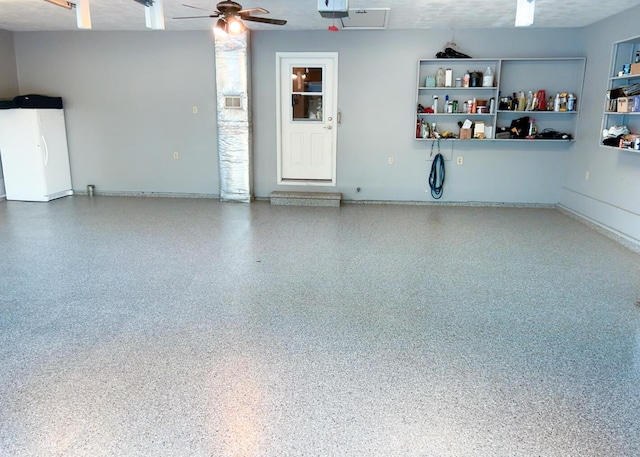 garage featuring ceiling fan and white refrigerator