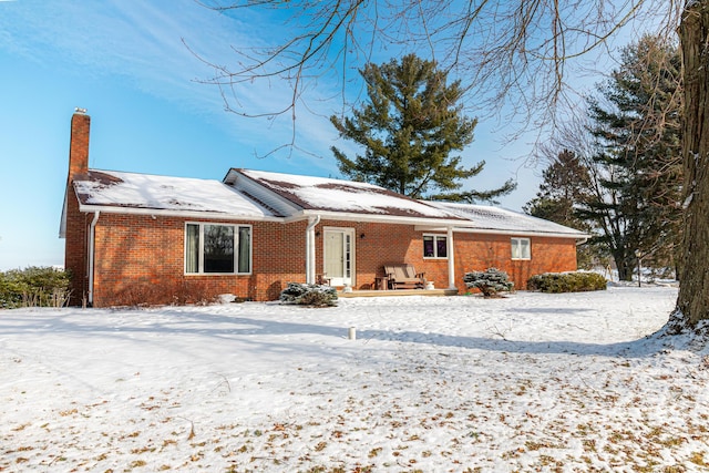 view of snow covered rear of property