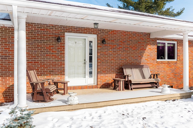 view of snow covered property entrance