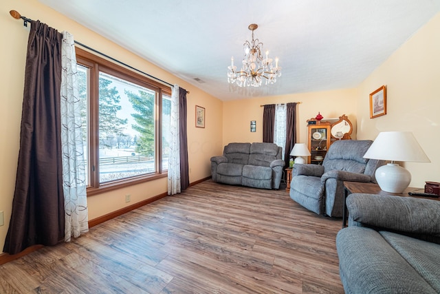 living room with an inviting chandelier and hardwood / wood-style floors