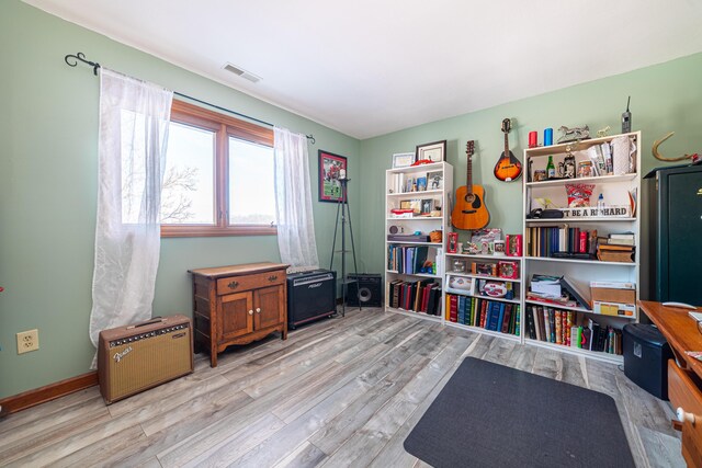 recreation room with light wood-type flooring