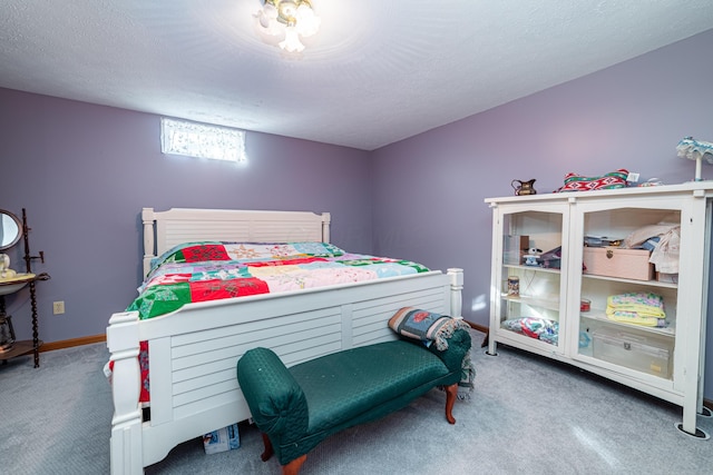 carpeted bedroom featuring a textured ceiling