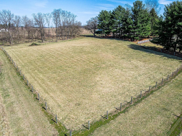 view of yard with a rural view and fence
