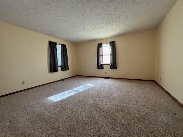 unfurnished room featuring carpet floors and a textured ceiling