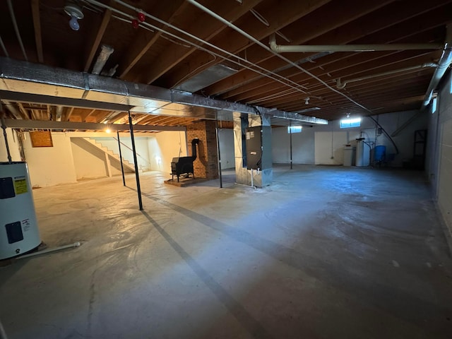 basement with electric water heater and heating unit