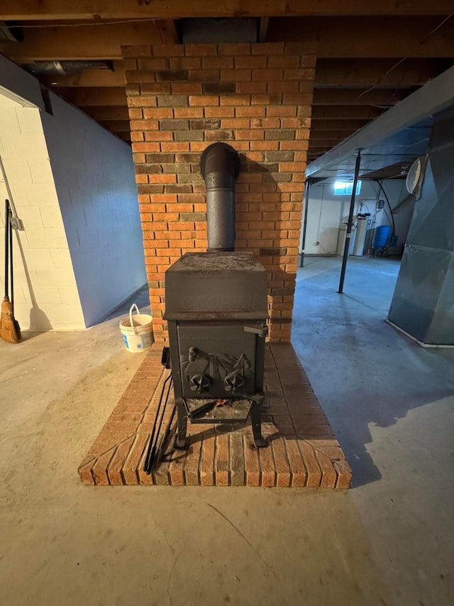 details with a wood stove and concrete floors