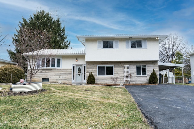 tri-level home featuring a carport and a front yard