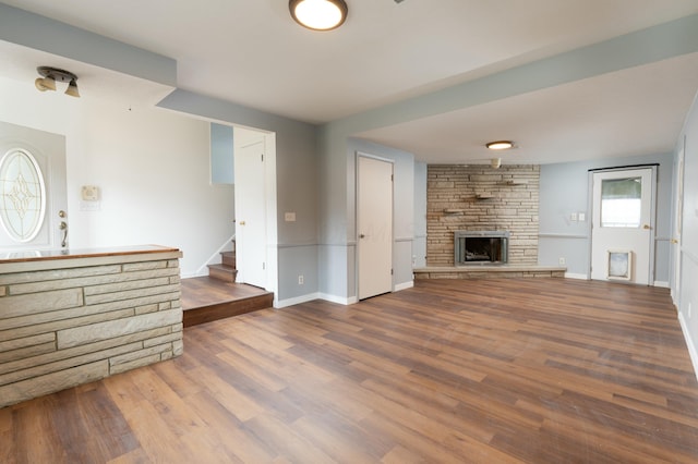 unfurnished living room with a fireplace and wood-type flooring